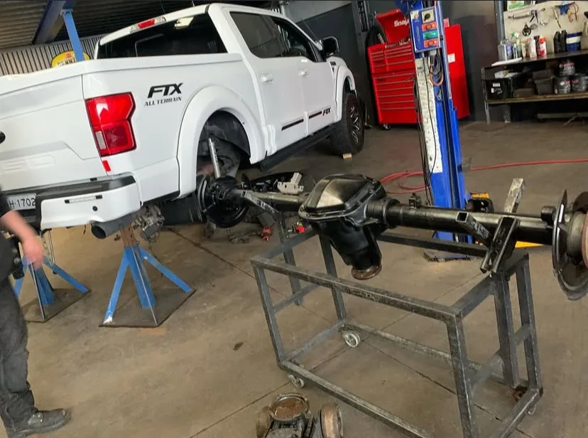 Ute on stands with rear diff and axle removed in the Driveline Gears workshop