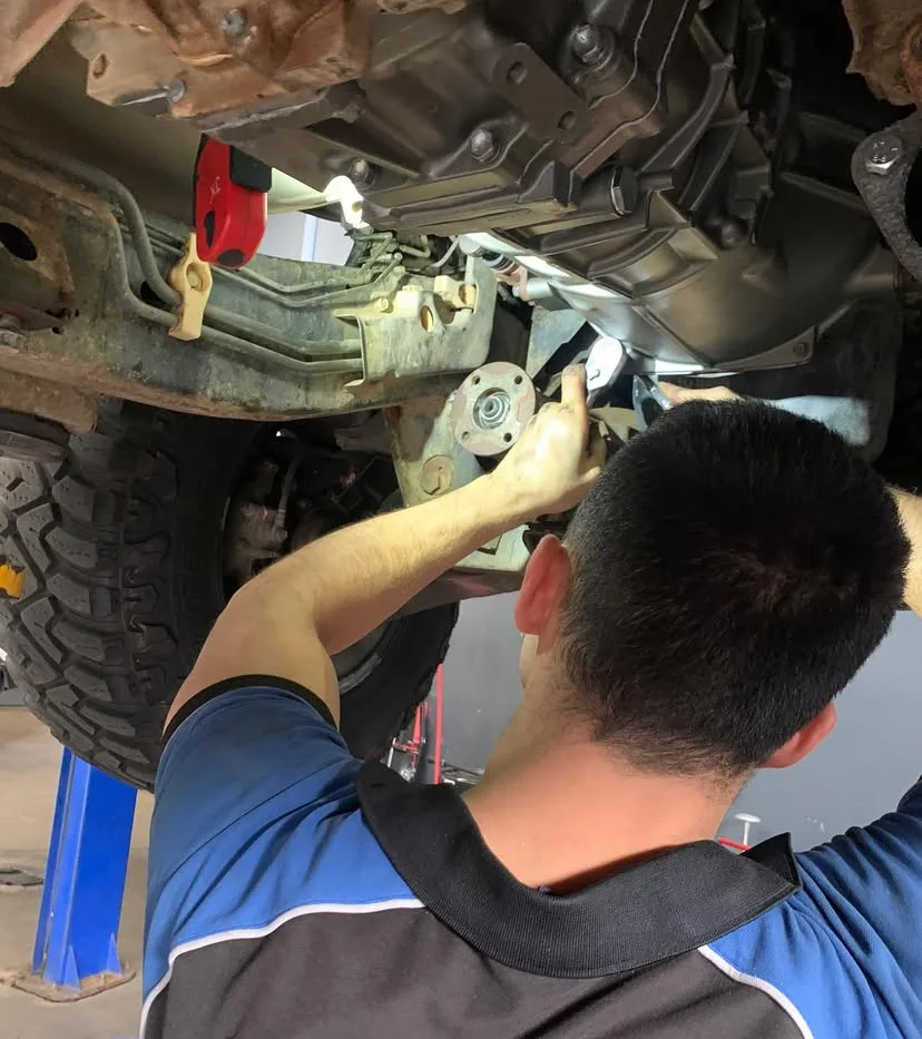 Driveline Gears mechanic working underneath a 4WD