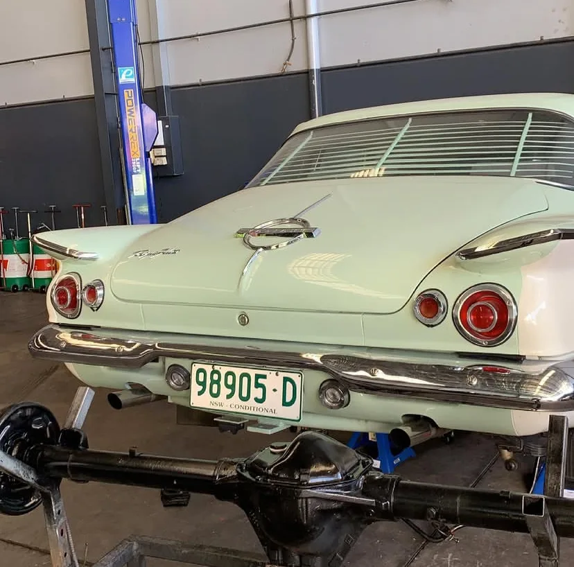 Classic vintage car in the workshop with a rear diff and tailshaft on the stand